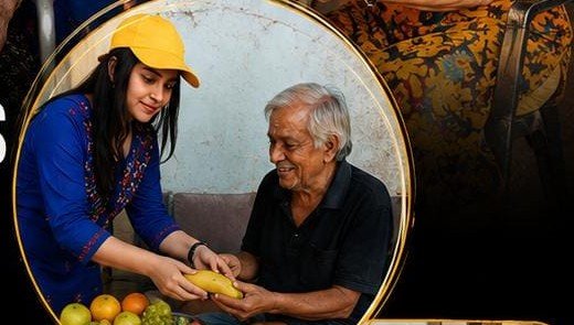 Volunteer sharing fruit with elderly man