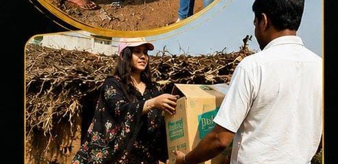 Volunteer handing box of supplies